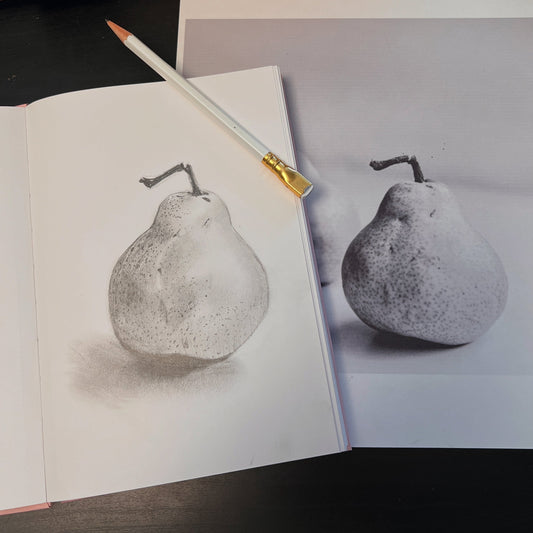 pencil sketch of a pear in a sketchbook