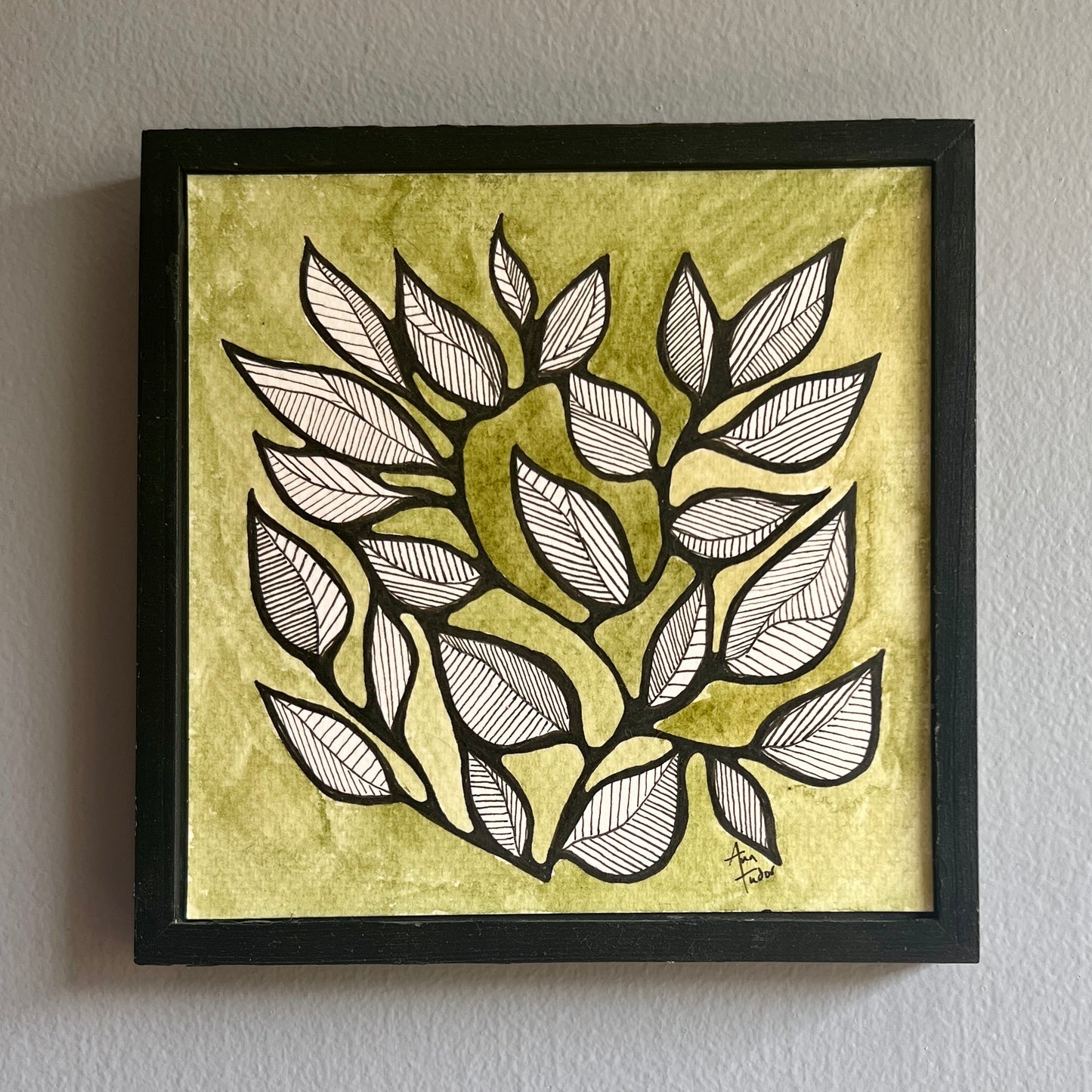 Black pen drawing of stylized leaves on a green watercolor background