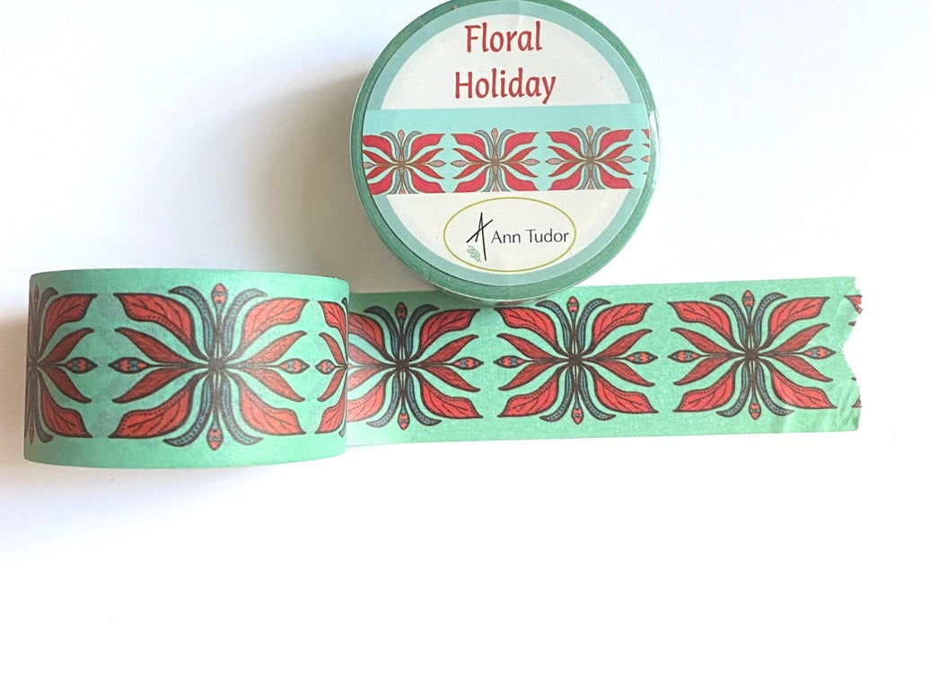 Washi tape with a red and dark turquoise art deco design on light turquoise background off of roll