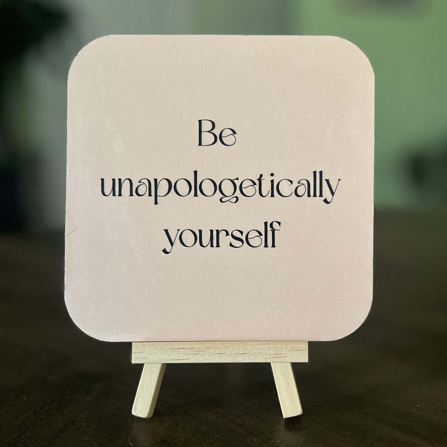 Small 5x5 art piece titled Estelle with the message ‘Be unapologetically yourself’ printed on the back; collectible artwork with display easel.