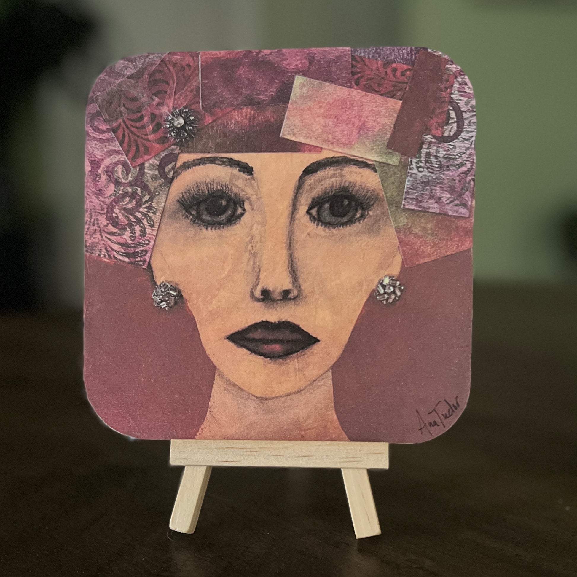 Ellamae is a 5x5 mixed-media art board from the Women + Words series — a collectible piece with a hidden message and mini easel