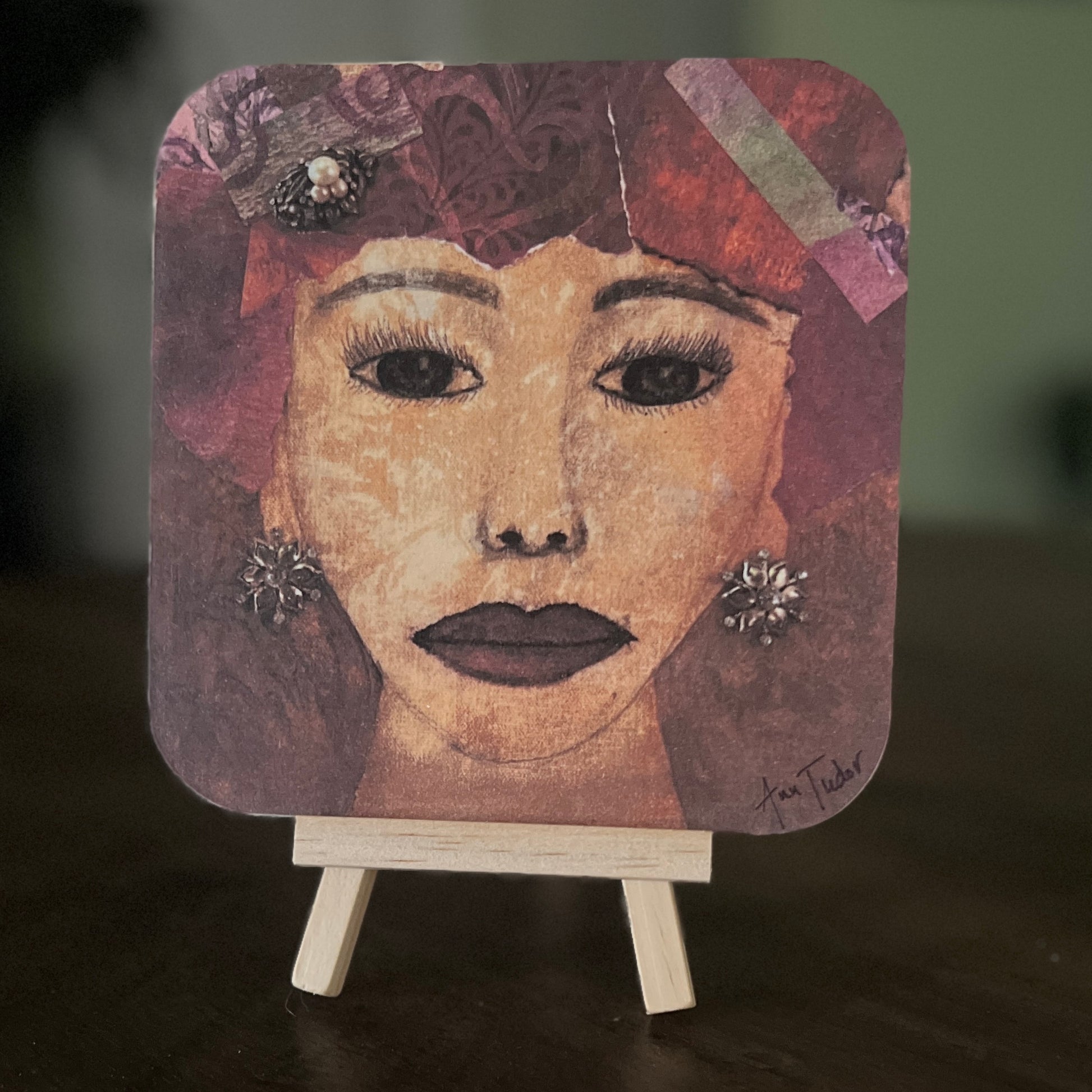 Maude is a 5x5 mixed-media art board from the Women + Words series — a collectible piece with a hidden message and mini easel.